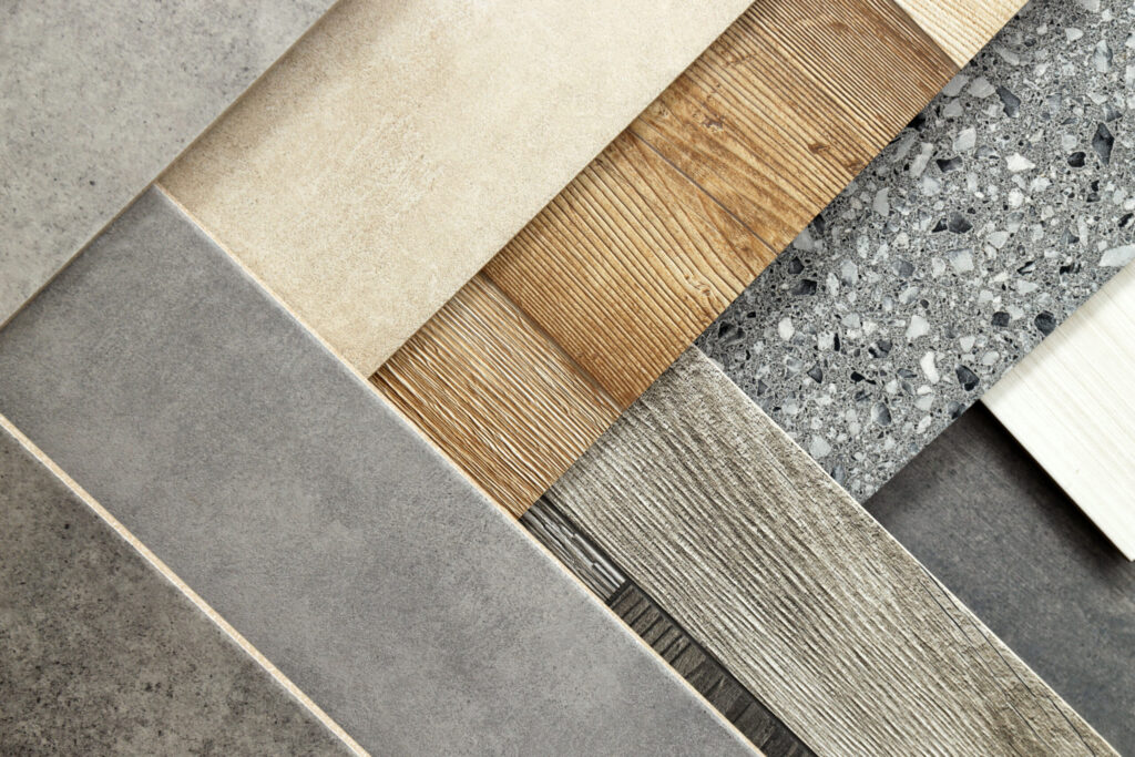 Assorted tile and stone flooring samples arranged on a surface